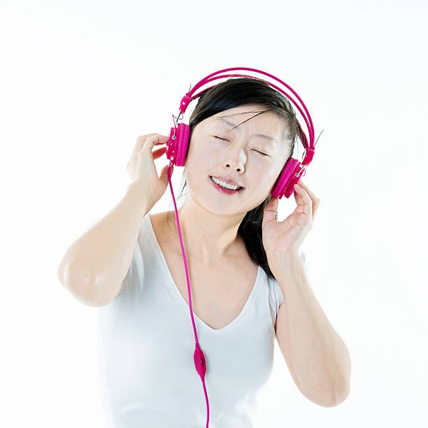 Young woman enjoying music, isolated on white background.
