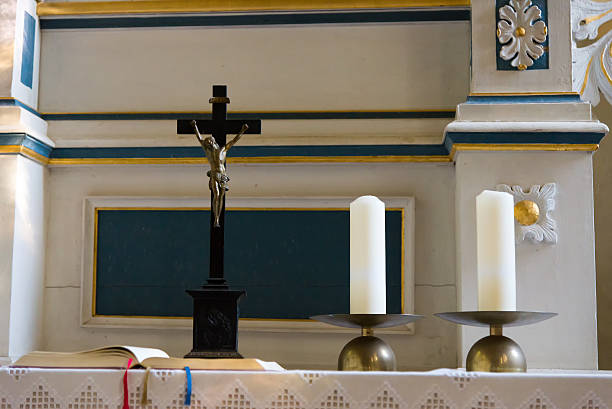istock candles, cross and bible on an altar 494421434