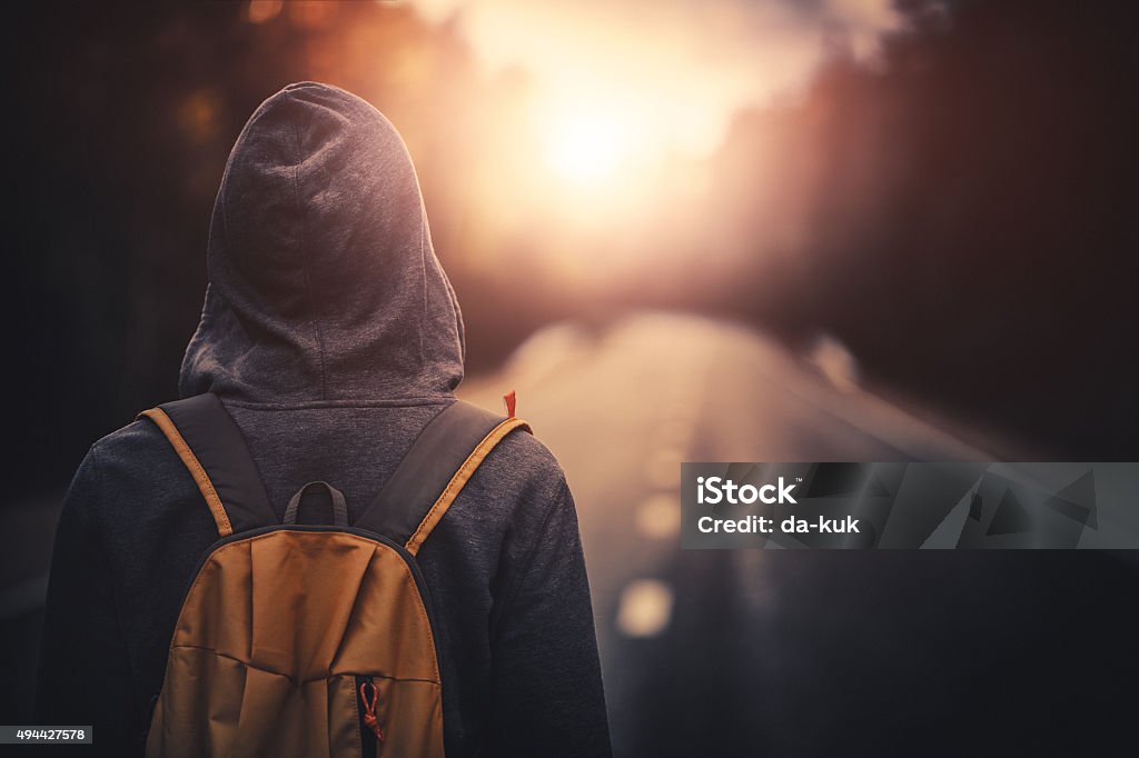 Traveler With Backpack Walking Forward Alone At Sunset Stock Photo -  Download Image Now - iStock