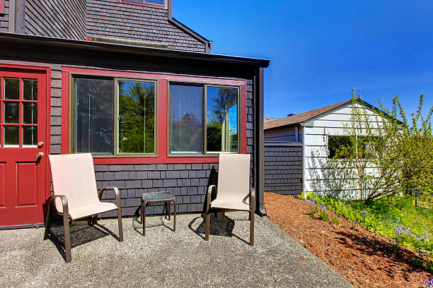 istock Two chairs next to red door and small black house. 494432697