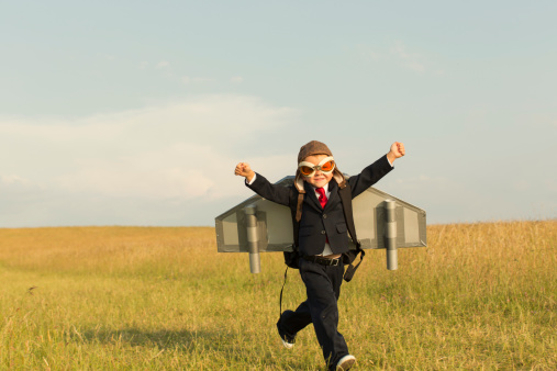 Joven niño vestido inglés en traje Jetpack de uso photo