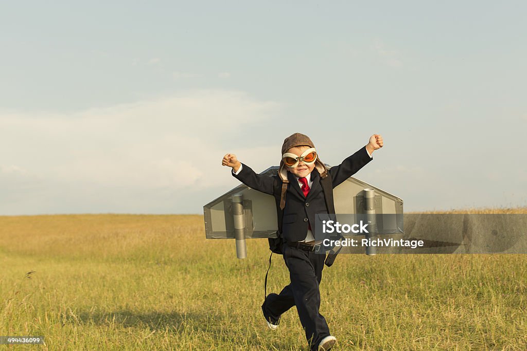 Young English Boy Dressed in Suit Wearing Jetpack A young boy is ready to take is European business to unknown heights. Child Stock Photo