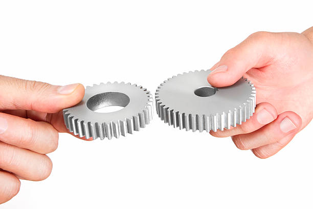 istock Two Business People Holding Gears 494438370