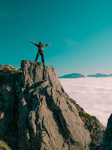 istock Toned image adult man with backpack stands on edge cliff 494439426