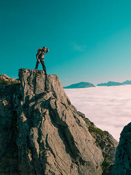 istock Toned image adult man with backpack stands on edge cliff 494439476