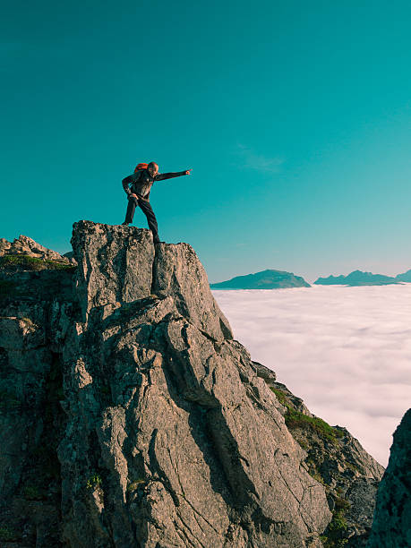 istock Toned image adult man with backpack stands on edge cliff 494439532