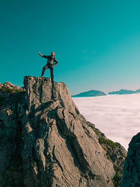istock Toned image adult man with backpack stands on edge cliff 494439588