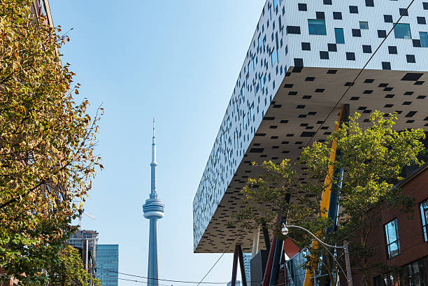 Sharp Centre for Design, Ontario College of Art Toronto, Canada - September 5, 2015: Low-angle view of the modern expansion of the Sharp Centre for Design at the campus of the Ontario College of Art (OCAD) in downtown Toronto, with the CN tower in the background. The building consists of an elevated white and black box supported by a series of multicolored inclined pillars. ocad stock pictures, royalty-free photos & images
