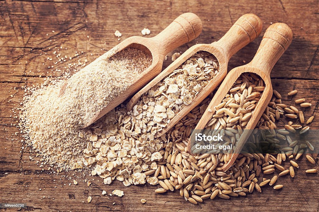 Oat flakes, seeds and bran Oat flakes, seeds and bran in spoons Wholegrain Stock Photo