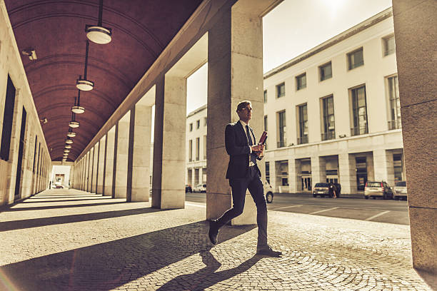 istock Business man walking in a colonnade 494441896