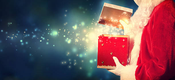 istock Santa Claus opening a red Christmas present 494441982