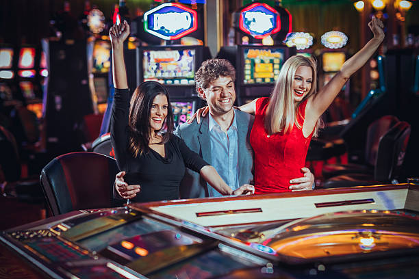 Excited Friends Gambling At Electronic Roulette In Casino Stock Photo - Download Image Now - iStock