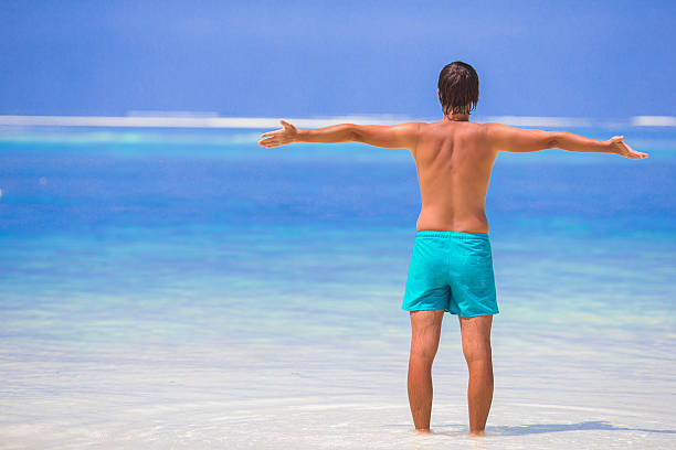 istock Young man enjoying summer vacation on tropical beach 494446802