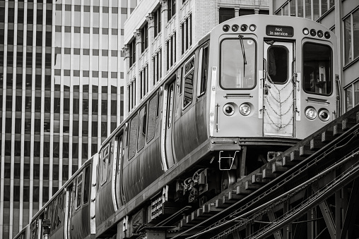 Monochromatic Chicago L Train passing office buildings in The Loop.