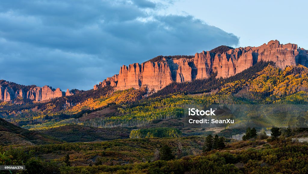 Sunset at Cimarron Ridge Autumn sunset view of the rugged Cimarron Ridge South, 11,526 ft (3,513 m), part of the San Juan Mountains, seen from Owl Creek Pass Road, near Ridgeway, Colorado, USA. Colorado Stock Photo