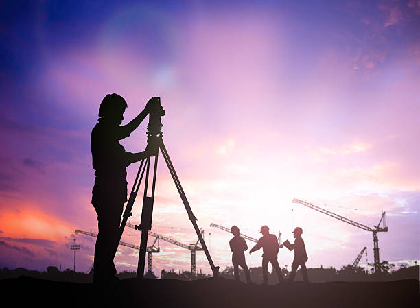 istock silhouette survey engineer working  in a building site over Blur 494465400