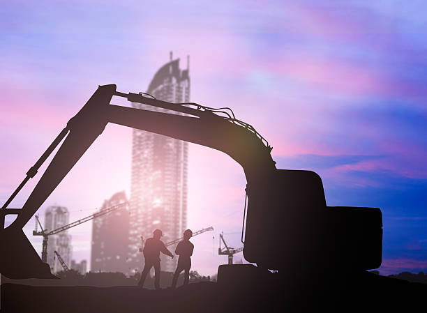istock silhouette Loaders and construction worker in a building site ov 494465968