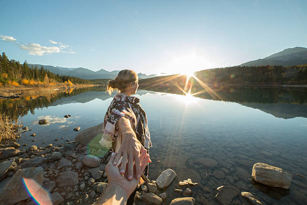 istock Young couple walking on the lake shore at sunrise 494466080