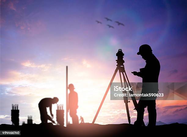 Silhouette Survey Engineer Working In A Building Site Over Blur Stock Photo - Download Image Now