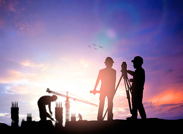 istock silhouette survey engineer working  in a building site over Blur 494466240