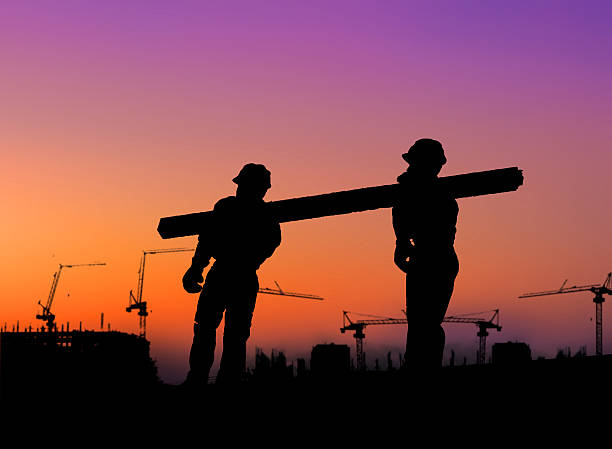 istock The group of workers working over blurred construction site. 494466560