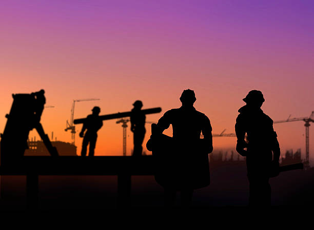 istock silhouette of architect looking at blueprints in a building site 494466594