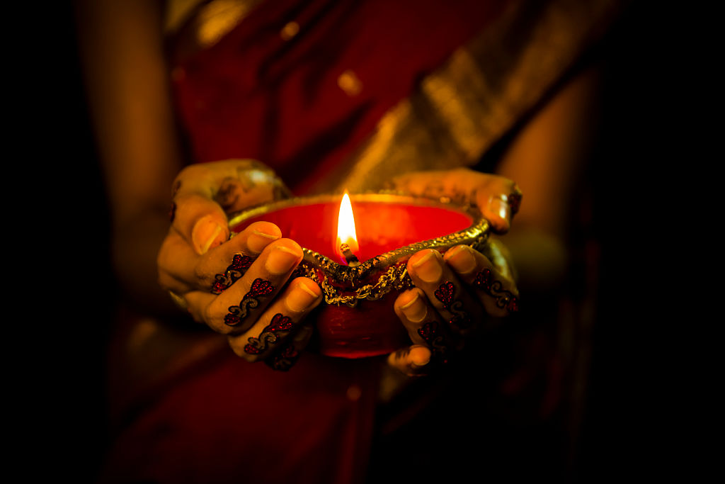 close up shot of femele hand holding diva on diwali festival with tatto on hand shot with full frame dslr nikon d750