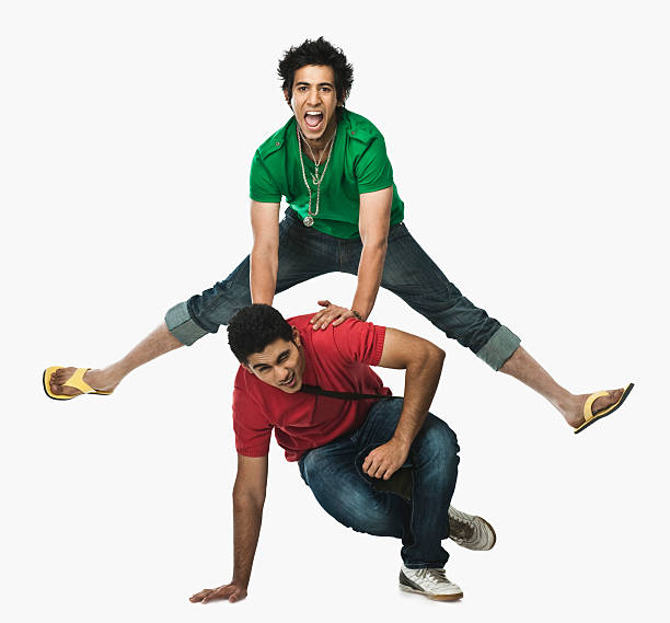 Two university students playing leapfrog Two university students playing leapfrog legs apart stock pictures, royalty-free photos & images