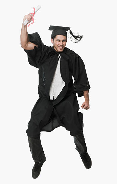 istock Man in a graduation gown holding a diploma and jumping 494470580