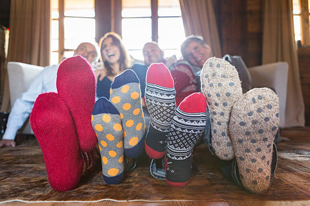 istock Winter home: family on living room carpet with wool socks 494470742
