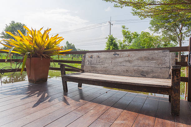 Weathered teak wood patio bench.