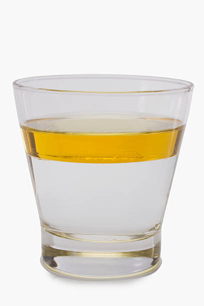 Oil floating on water surface in a glass