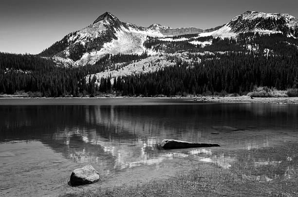 istock Black and white Colorado snow mountains reflecting in lake 494471224