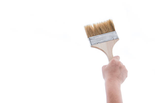 istock Paint brush with wooden handle of a human hand 494472582