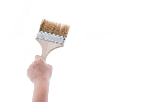 istock Paint brush with wooden handle of a human hand 494472614