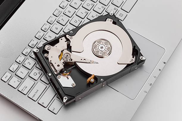 HDD over notebook keyboard HDD over notebook keyboard, selective focus hard drive photos stock pictures, royalty-free photos & images