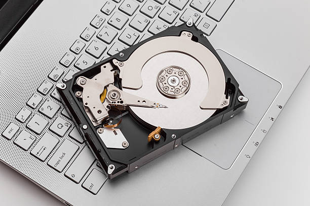 HDD over notebook keyboard stock photo