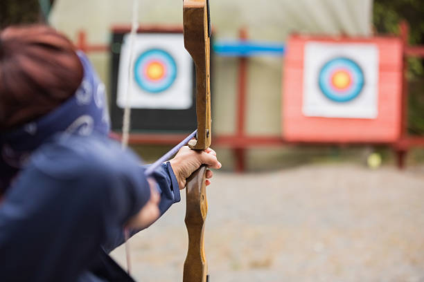 istock Brunette about to shoot arrow 494478393