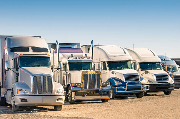 Generic semi-trucks in a parking lot Generic semi Trucks at a parking lot convoy stock pictures, royalty-free photos & images