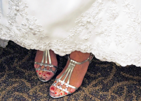 Pretty bride feet with red toe nails