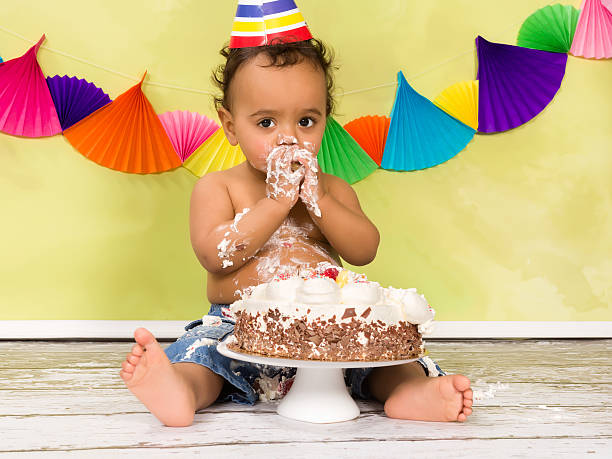 Baby first birthday Adorable african baby during a cake smash on his first birthday demolished photos stock pictures, royalty-free photos & images