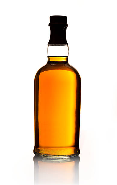 Whiskey Bottle A whiskey bottle with no label isolated on white. cognac brandy photos stock pictures, royalty-free photos & images