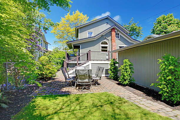 istock House with backyard sitting area and garage wall. 494486041