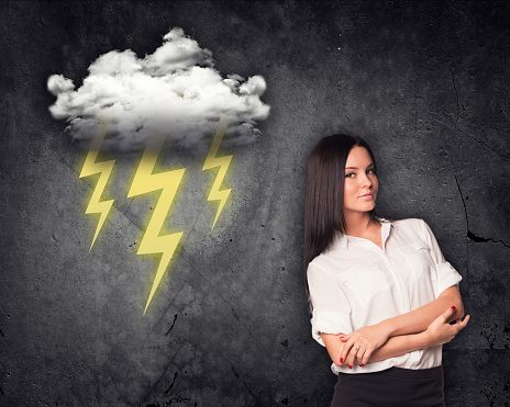 Businesswoman looking at camera with cloud and lightning on grey background