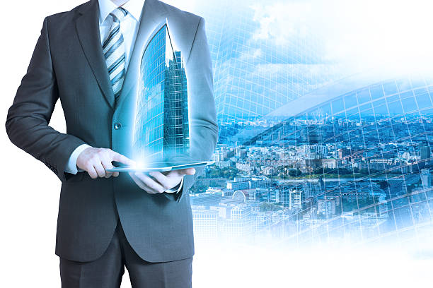 istock Businessman holding tablet with 3d buildings 494496120