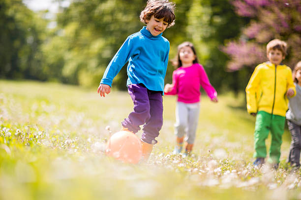 istock Little boy playing with ball in nature. 494496192