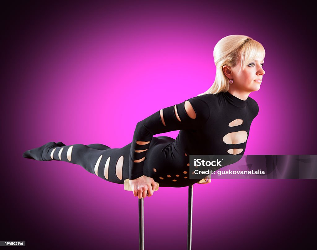 circus actor standing on the hand on a purple background Circus Stock Photo