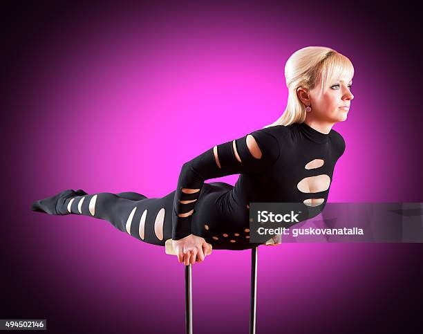 Circus Actor Standing On The Hand On A Purple Background Stock Photo - Download Image Now