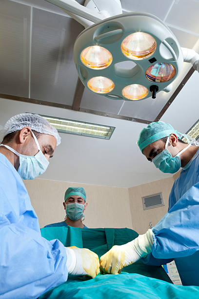 istock Two doctors and male nurse making surgery in operating room 494504464