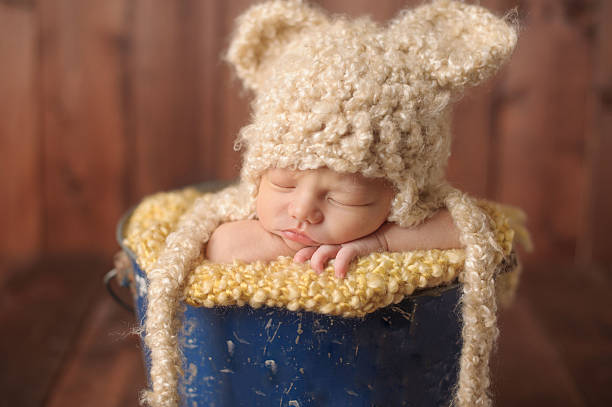 istock Newborn Boy Sleeping in Antique Bucket 494505287